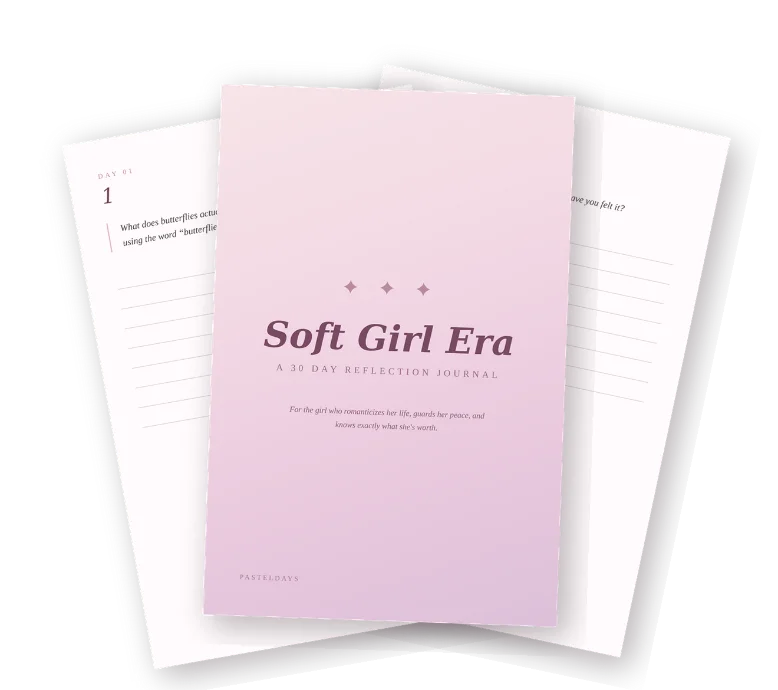 Soft Girl Era journal cover, a pastel pink 30-day reflection journal, resting over open journal pages